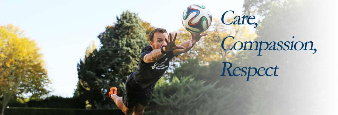 A man reaching for a soccer ball. The words 